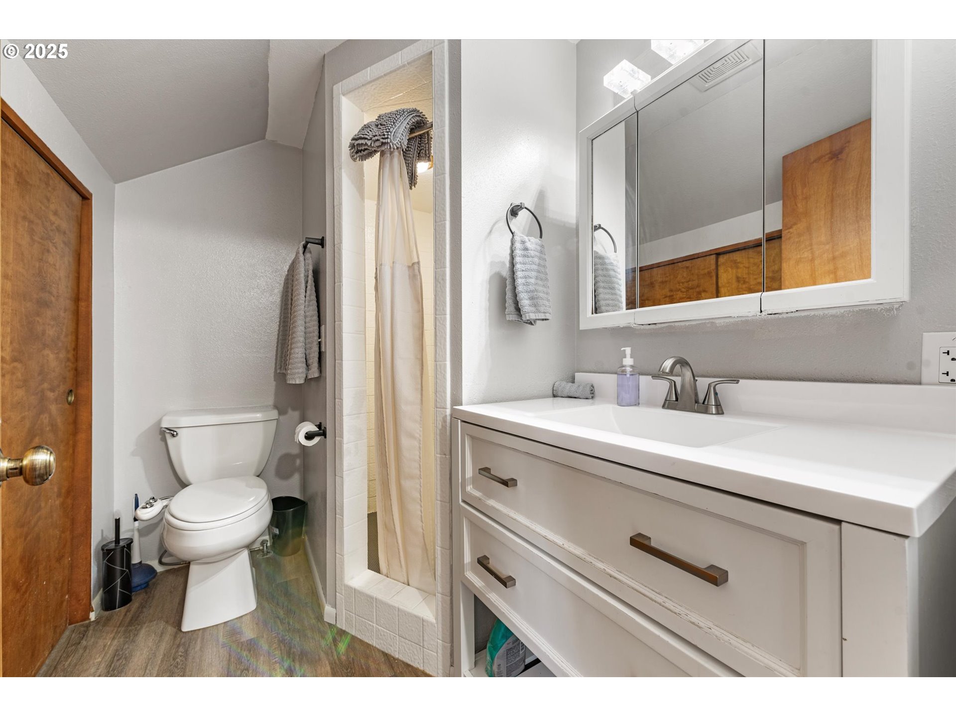 1805 East Street Baker City, OR 97814 - Photo 31 of 45 a bathroom with a sink a toilet a mirror and shower