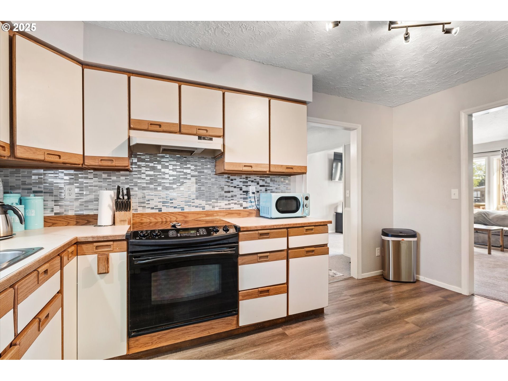 1805 East Street Baker City, OR 97814 - Photo 10 of 45 a kitchen with stainless steel appliances wooden cabinets and a stove top oven