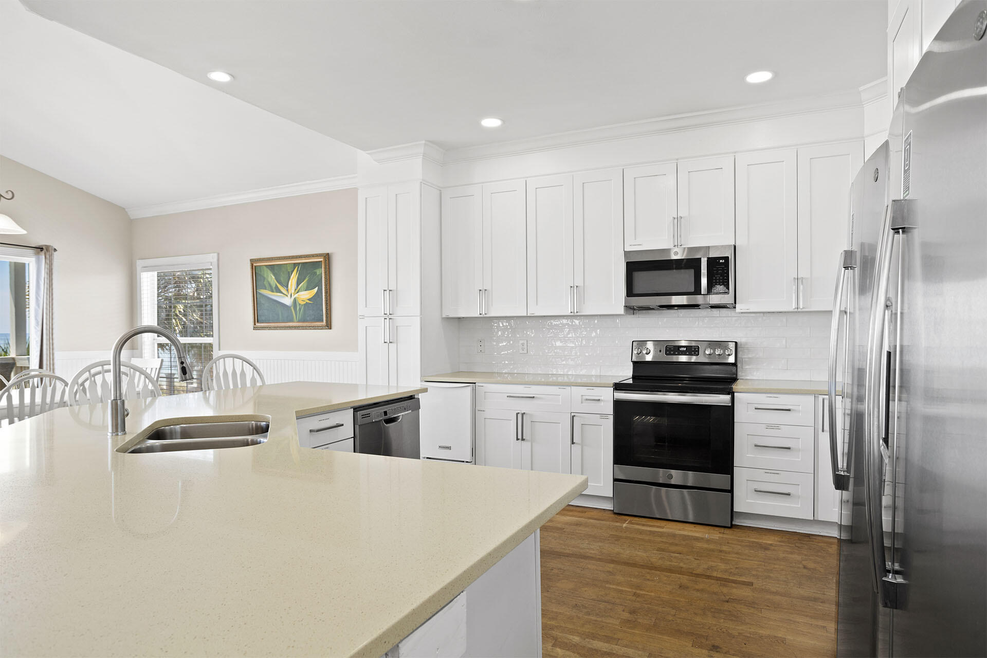 20 Sandy Beach Road Miramar Beach, FL 32550 - Photo 17 of 42 a kitchen with stainless steel appliances granite countertop a stove top oven a sink dishwasher a refrigerator and a dining table with wooden floor