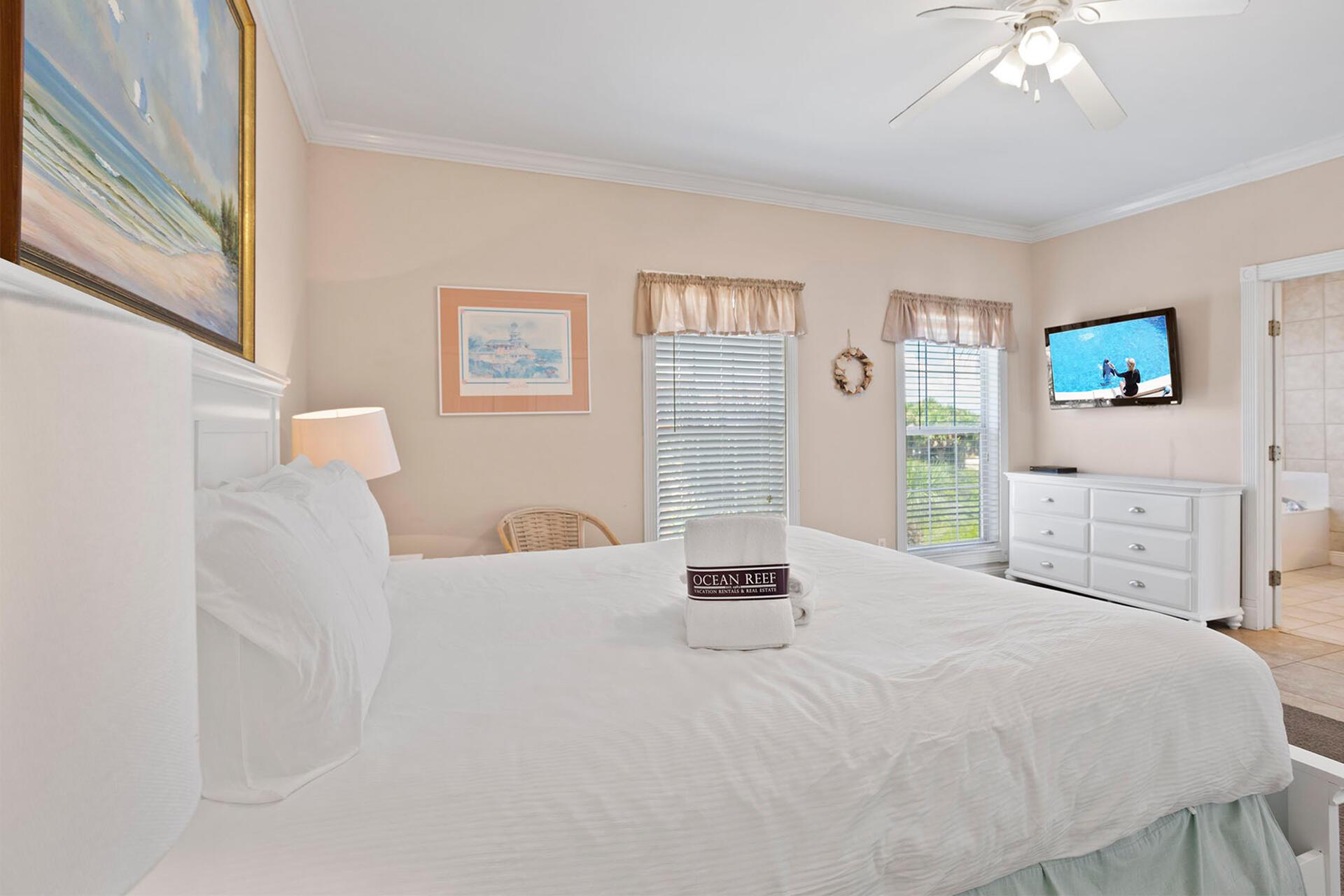 20 Sandy Beach Road Miramar Beach, FL 32550 - Photo 18 of 42 a bedroom with a bed and a chandelier