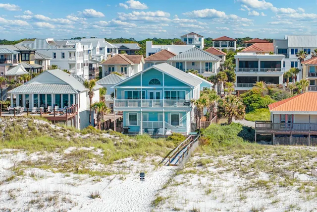 a view of residential houses with yard and swimming pool