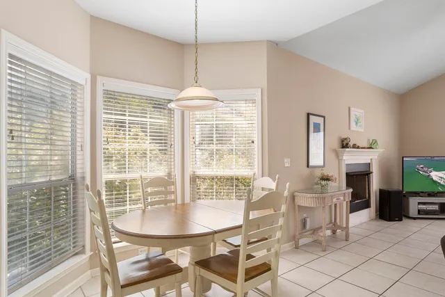 a white kitchen with sink a refrigerator and cabinets