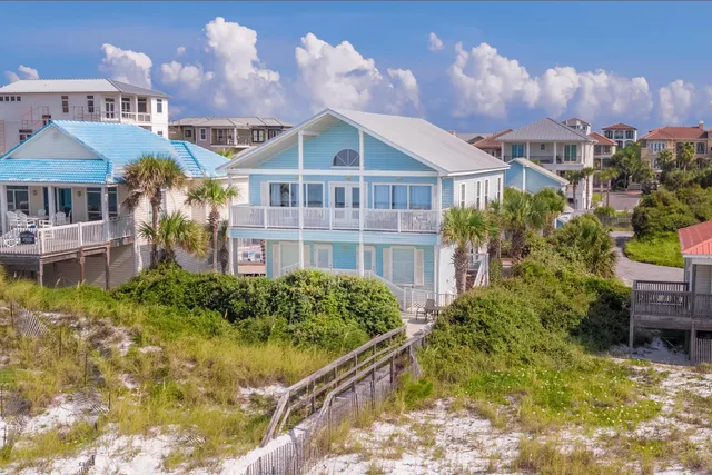 a front view of a residential houses with yard