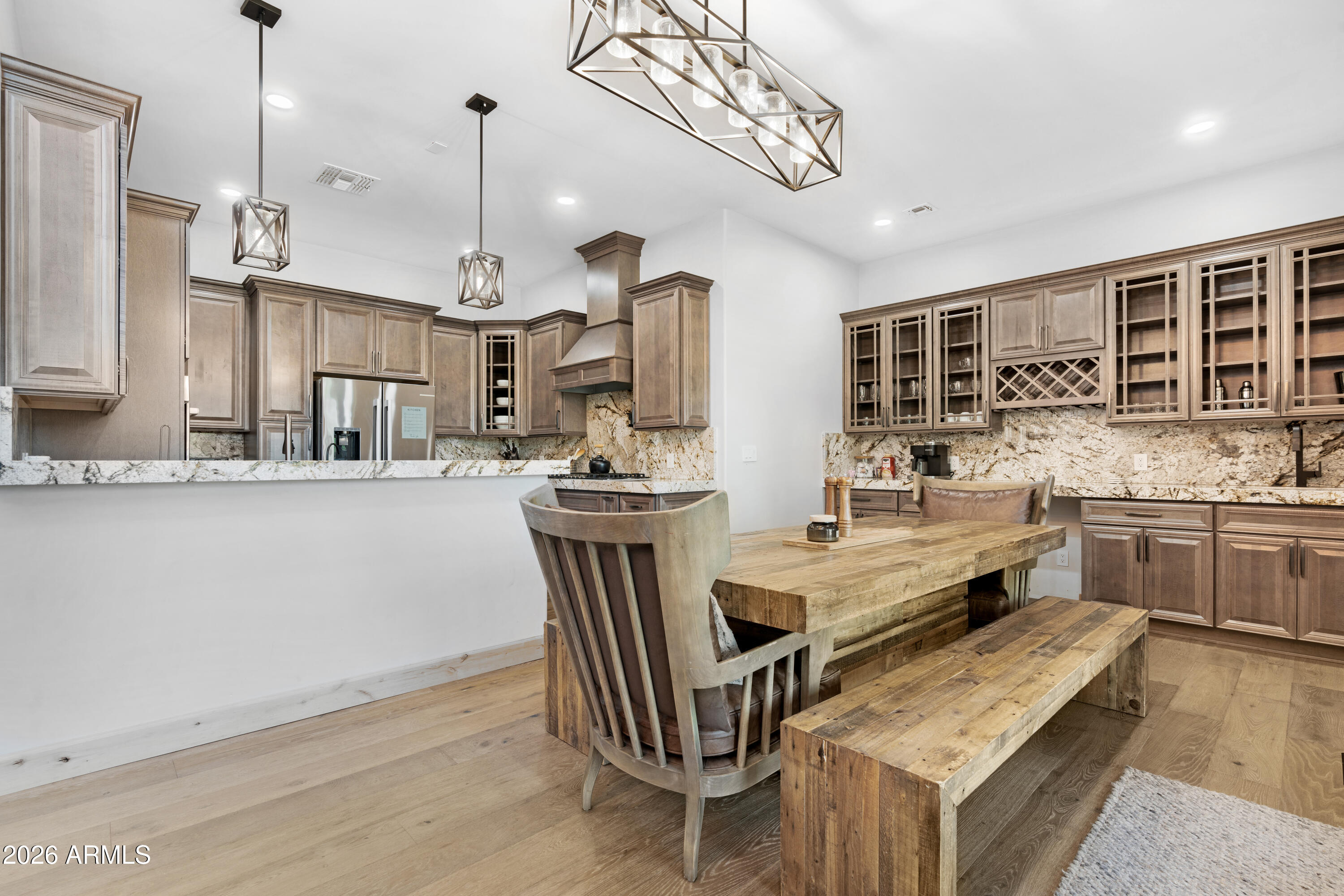 2238 Country Club Drive Overgaard, AZ 85933 - Photo 15 of 74 a kitchen with stainless steel appliances kitchen island granite countertop a refrigerator a stove a sink dishwasher with a dining table and chairs