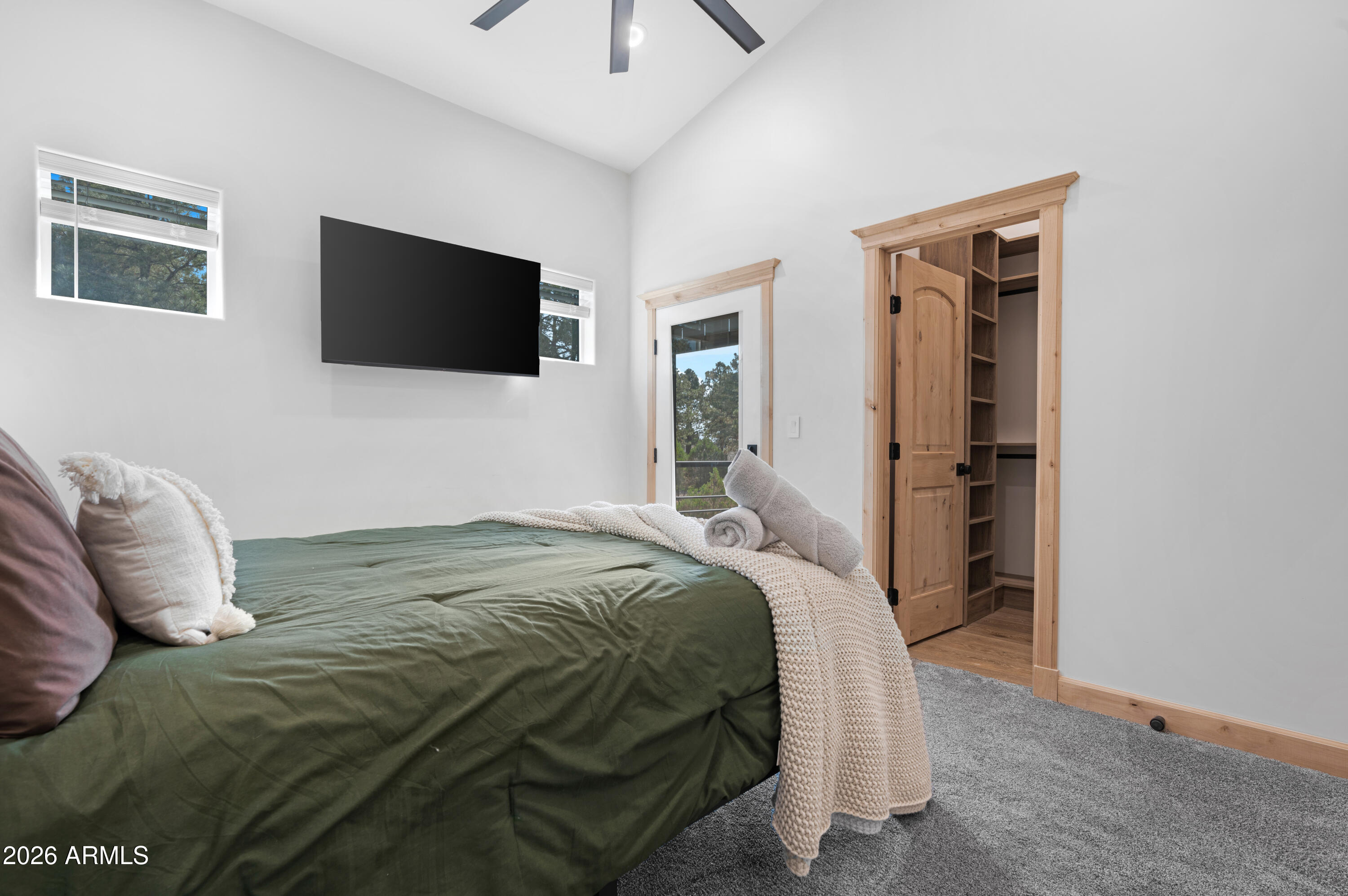 2238 Country Club Drive Overgaard, AZ 85933 - Photo 50 of 74 a bedroom with a bed and a flat screen tv