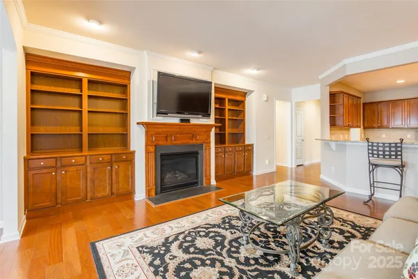 a living room with a flat screen tv and a fireplace