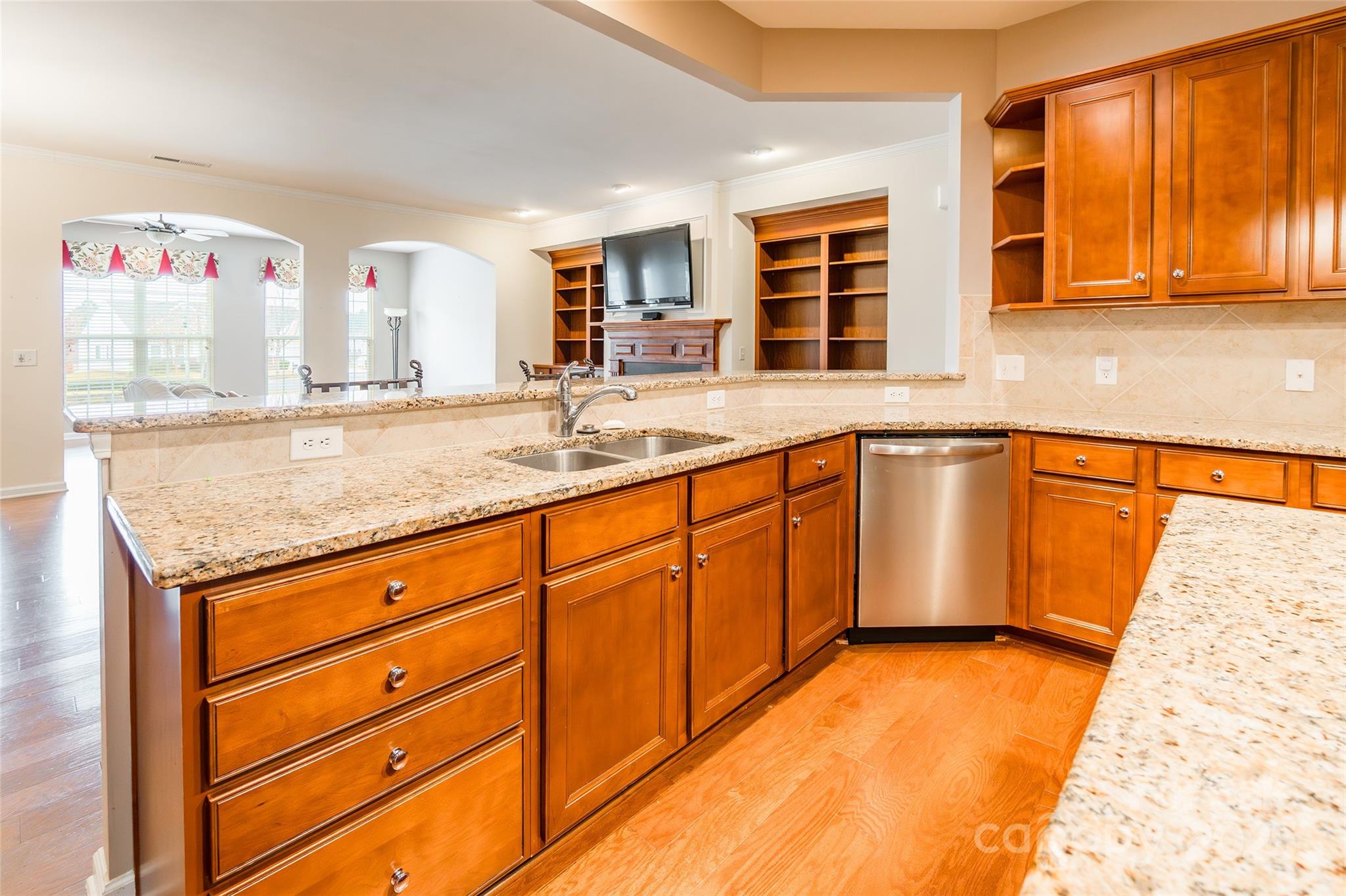 2050 Yellowstone Drive Fort Mill, SC 29707 - Photo 15 of 42 a kitchen with stainless steel appliances granite countertop a sink and dishwasher with wooden cabinets