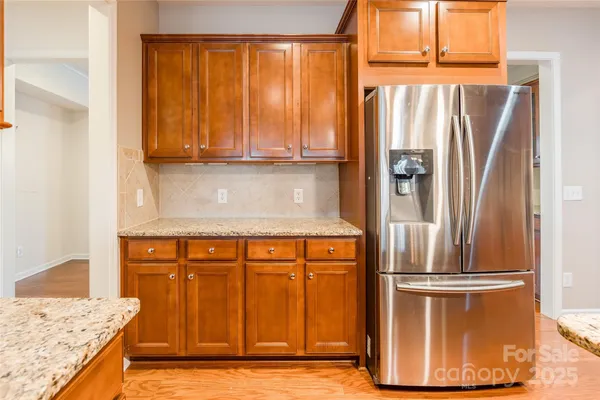 a kitchen with stainless steel appliances granite countertop a refrigerator and a sink
