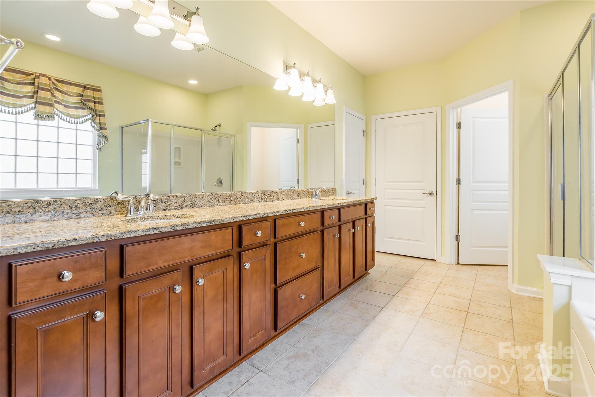 2050 Yellowstone Drive Fort Mill, SC 29707 - Photo 27 of 42 a bathroom with a granite countertop sink mirror and a