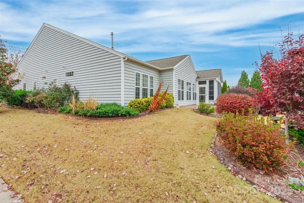 a front view of house with yard and trees around