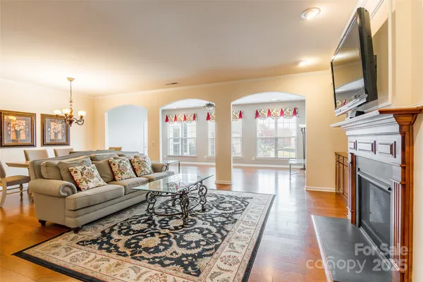 a living room with fireplace furniture and a rug