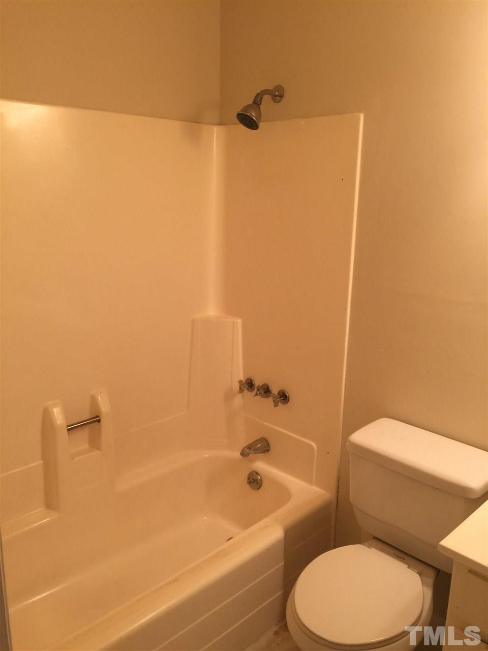 706 Godwin Court Raleigh, NC 27606 - Photo 11 of 19 a white toilet sitting next to a bath tub
