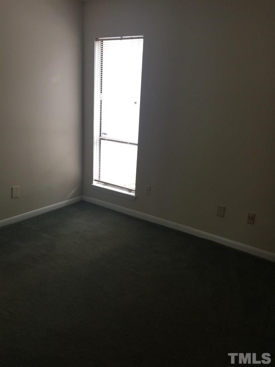 706 Godwin Court Raleigh, NC 27606 - Photo 13 of 19 an empty room with a window