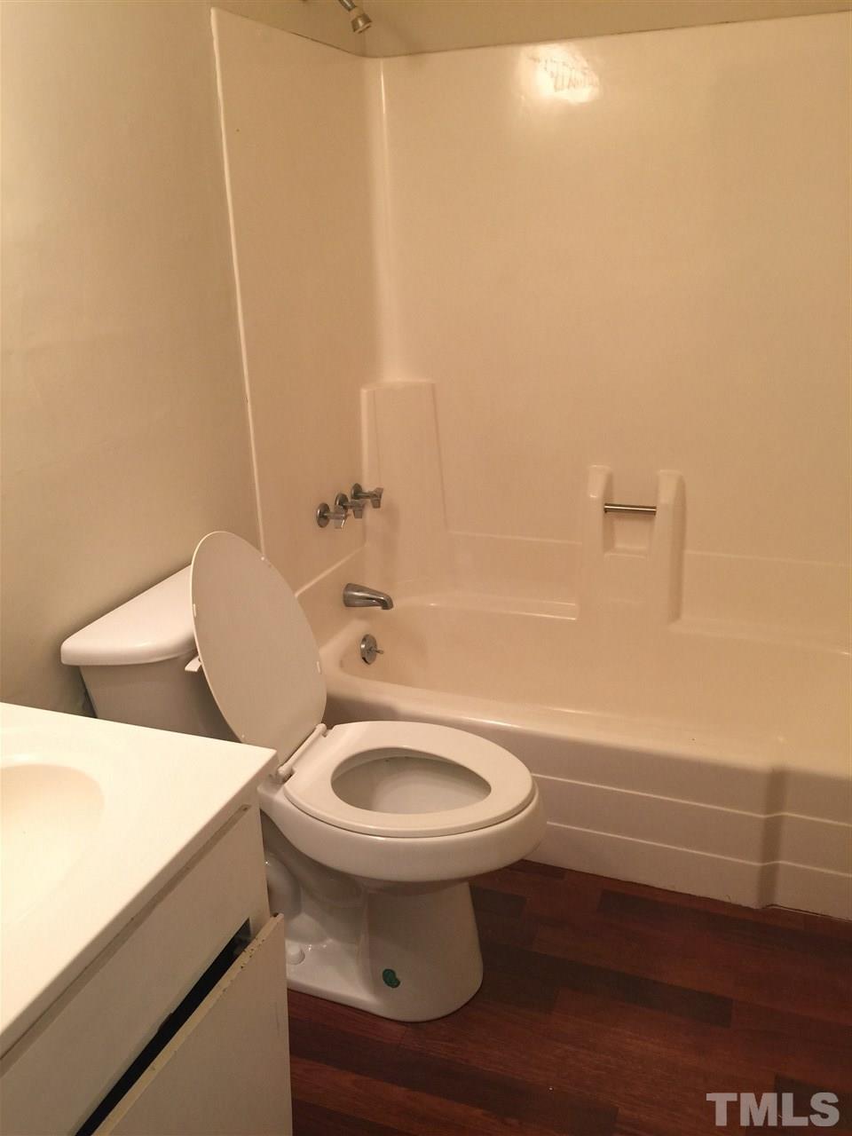 706 Godwin Court Raleigh, NC 27606 - Photo 16 of 19 a bathroom with a sink a toilet and tub