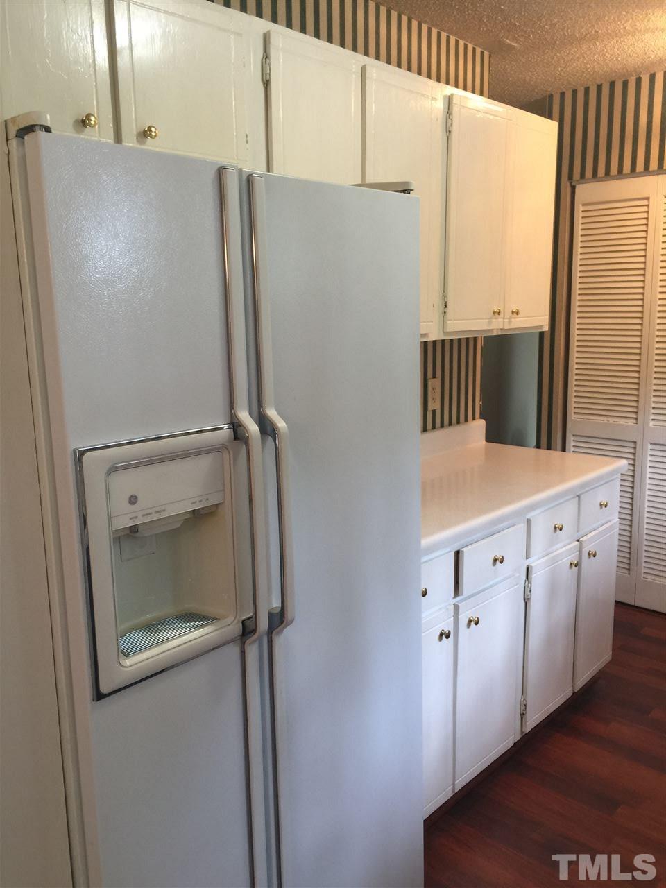 706 Godwin Court Raleigh, NC 27606 - Photo 5 of 19 a white refrigerator freezer sitting inside of a kitchen