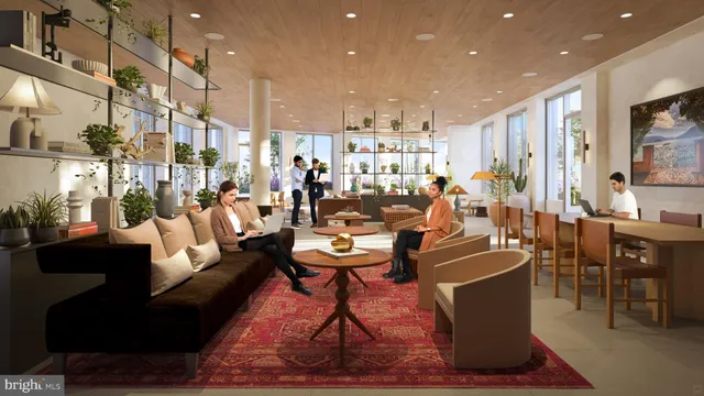 a living room with lots of furniture and a painting on the wall