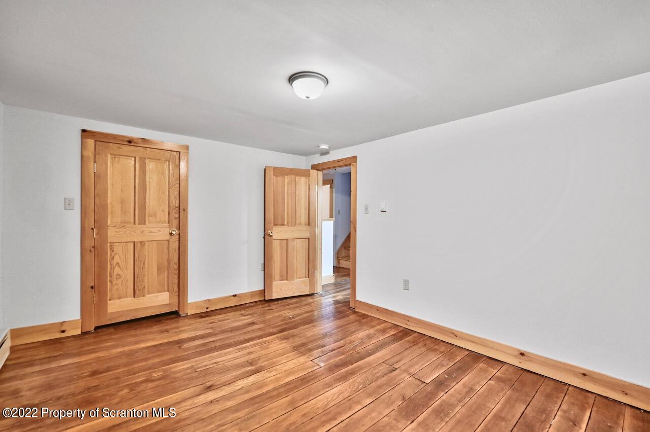 549 Gravity Road Lake Ariel, PA 18436 - Photo 31 of 62 a view of an empty room with wooden floor and a window