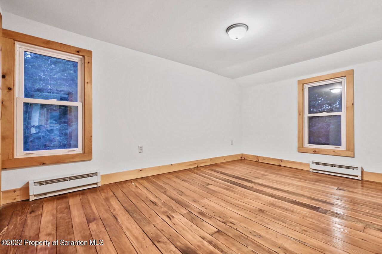 549 Gravity Road Lake Ariel, PA 18436 - Photo 36 of 62 a view of an empty room with wooden floor and a window