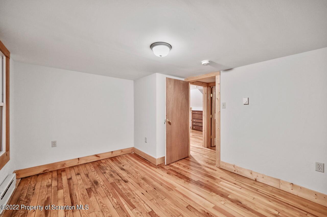 549 Gravity Road Lake Ariel, PA 18436 - Photo 46 of 62 a view of empty room with wooden floor and fan