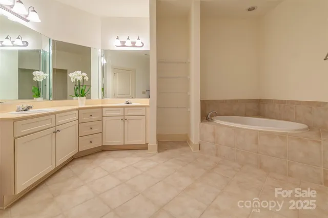 a spacious bathroom with a mirror a sink and a mirror