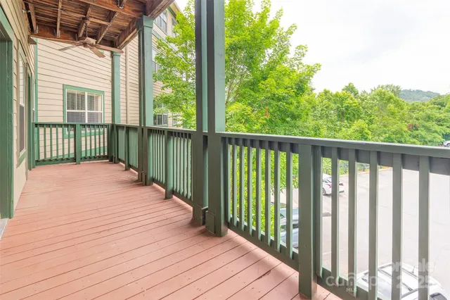 a balcony with view of trees in the background