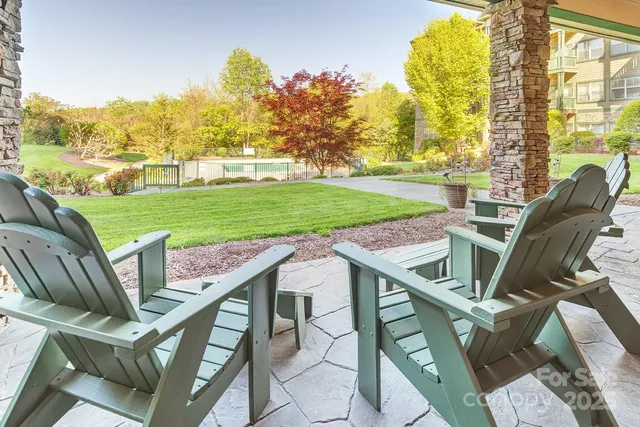 a view of a patio with a table chairs and a backyard