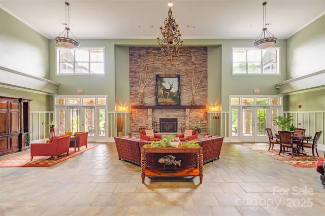 a living room with fireplace furniture and a chandelier