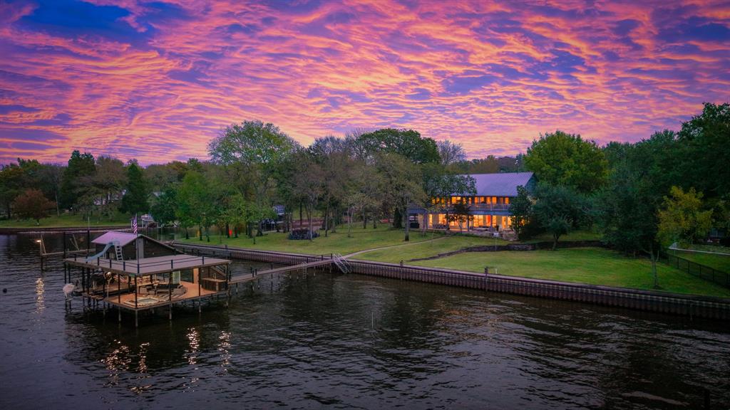 258 Sunset Point Mabank, TX 75156 - Photo 1 of 40 a view of a lake with a house in the background