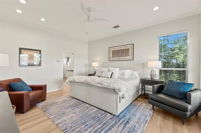 a bedroom with a large bed and a window