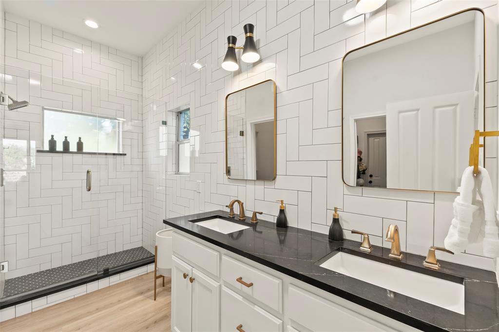 258 Sunset Point Mabank, TX 75156 - Photo 18 of 40 a bathroom with a double vanity sink a mirror and a shower