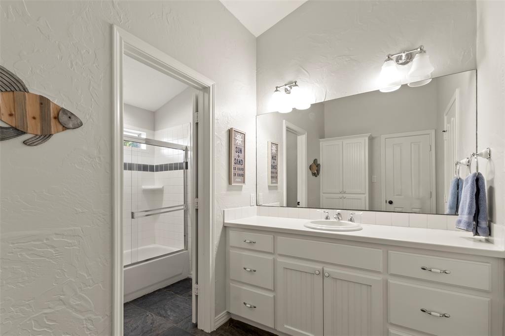 258 Sunset Point Mabank, TX 75156 - Photo 27 of 40 a bathroom with a shower sink and mirror