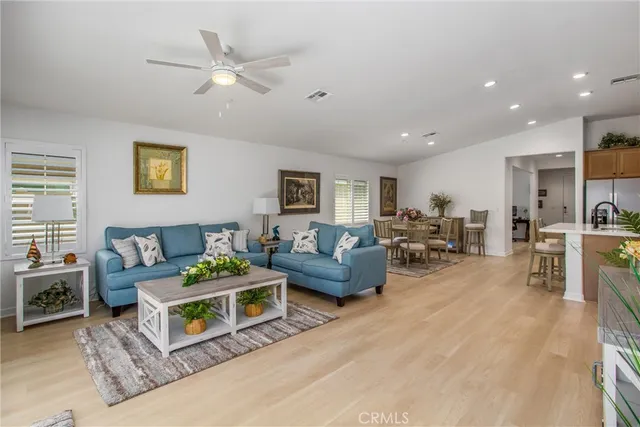 a living room with furniture and view of kitchen