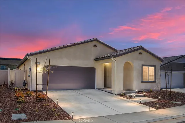 a view of a house with a yard and a garage