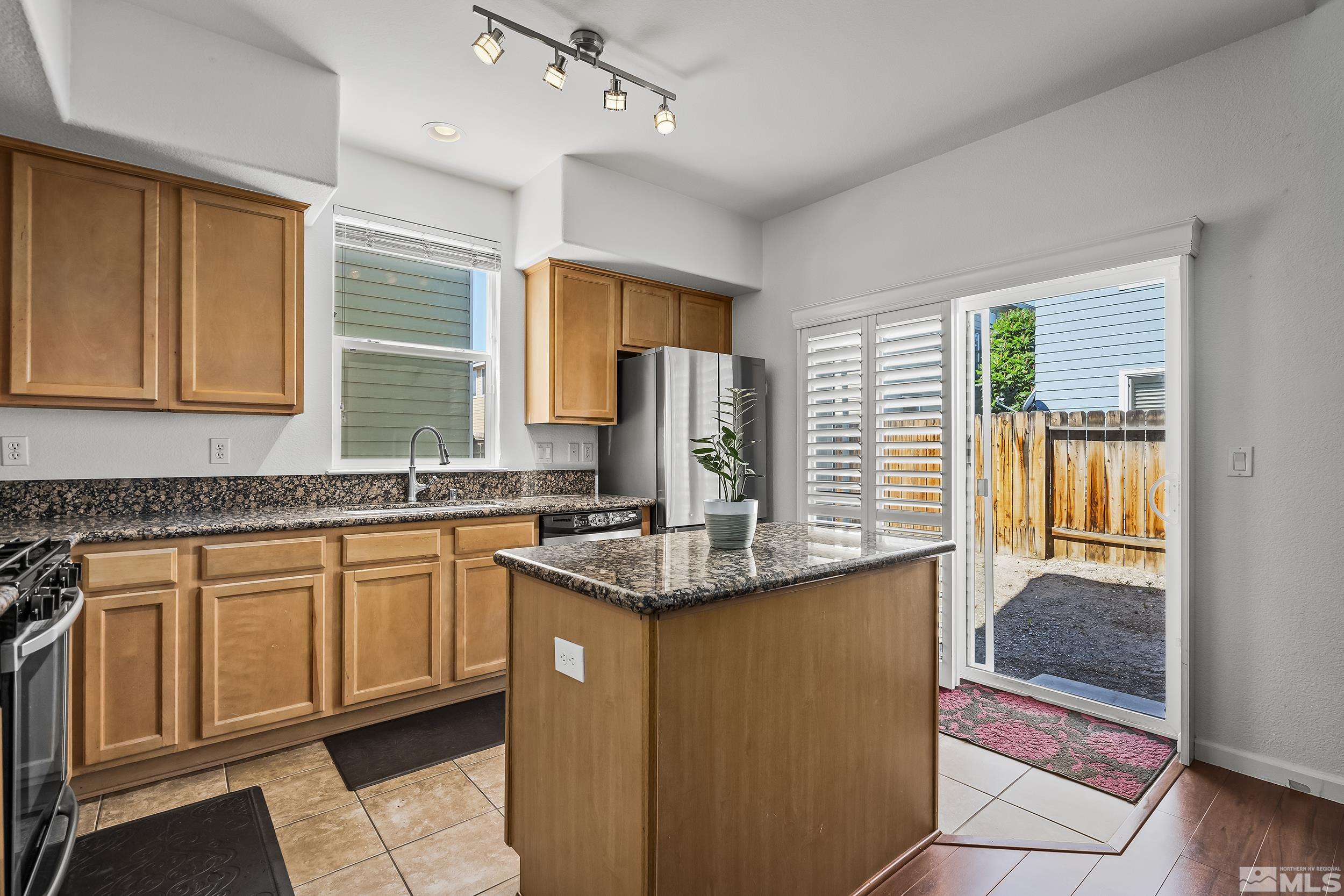 2115 Stanton Lane Reno, NV 89502 - Photo 6 of 18 a kitchen with stainless steel appliances granite countertop sink stove and refrigerator