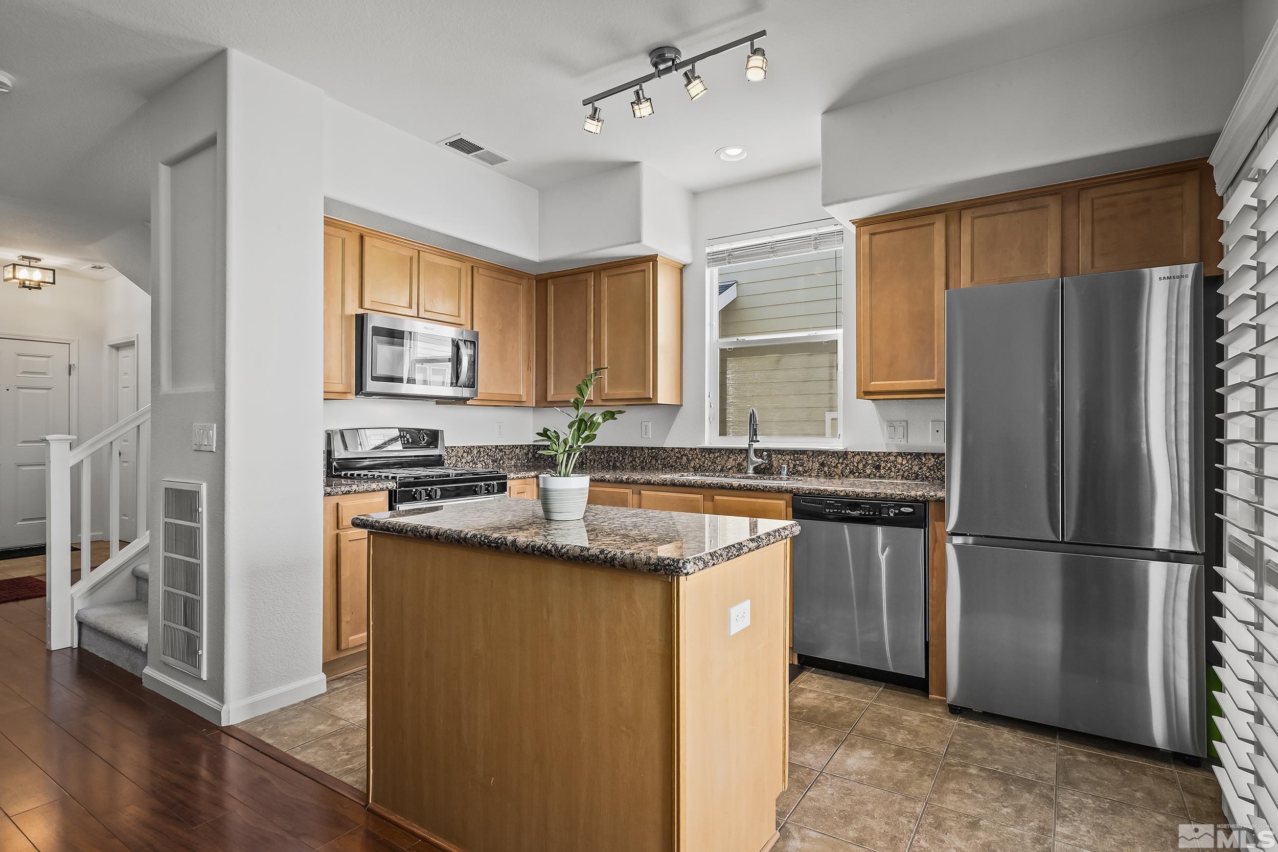 2115 Stanton Lane Reno, NV 89502 - Photo 7 of 18 a kitchen with stainless steel appliances granite countertop a refrigerator a sink dishwasher a stove and a refrigerator