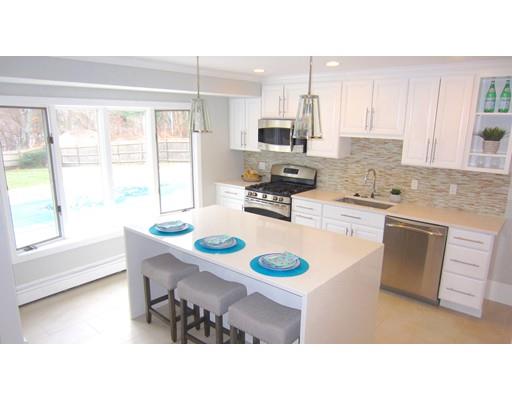 108 Pine Ridge Road Medford, MA 02155 - Photo 6 of 25 a kitchen with kitchen island a sink table and chairs