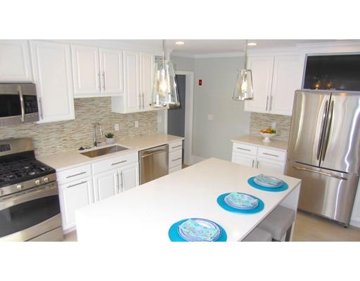 108 Pine Ridge Road Medford, MA 02155 - Photo 7 of 25 a kitchen with a refrigerator a stove a sink dishwasher and white cabinets with wooden floor