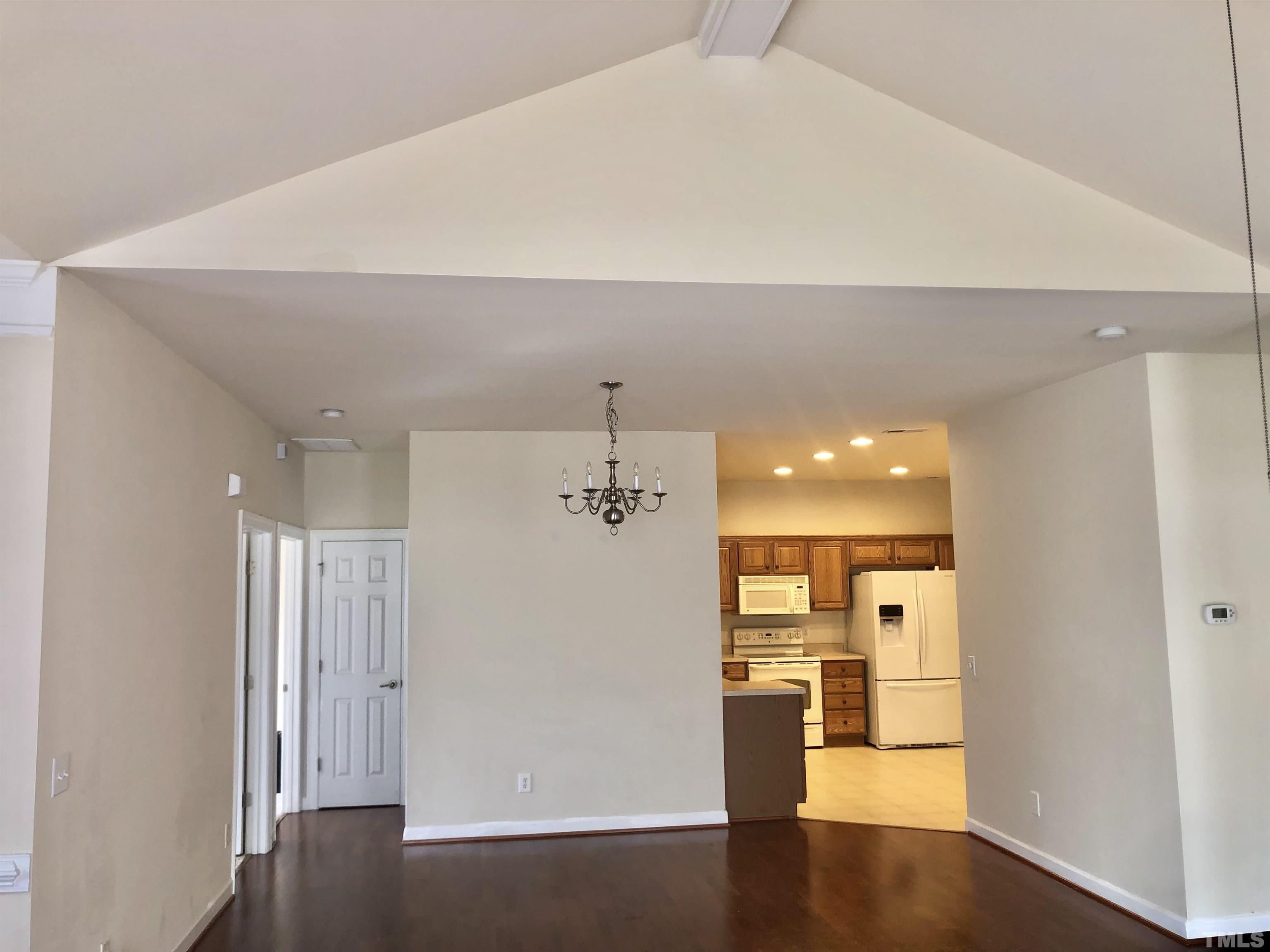 4720 Fox Fern Lane Raleigh, NC 27604 - Photo 14 of 20 a view of a hallway with wooden floor windows and a bathroom