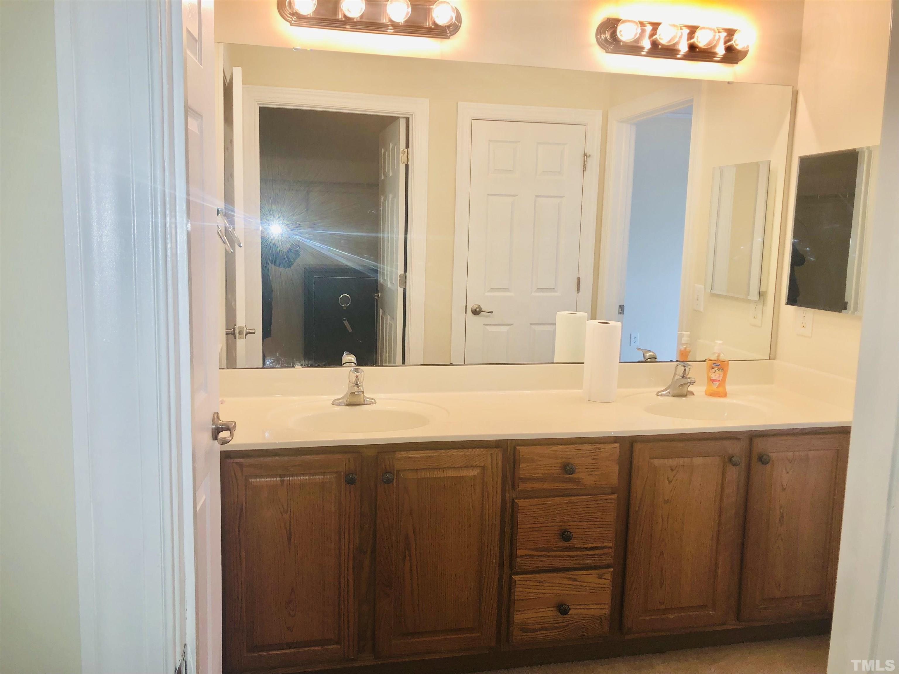 4720 Fox Fern Lane Raleigh, NC 27604 - Photo 20 of 20 a bathroom with a granite countertop sink and a mirror