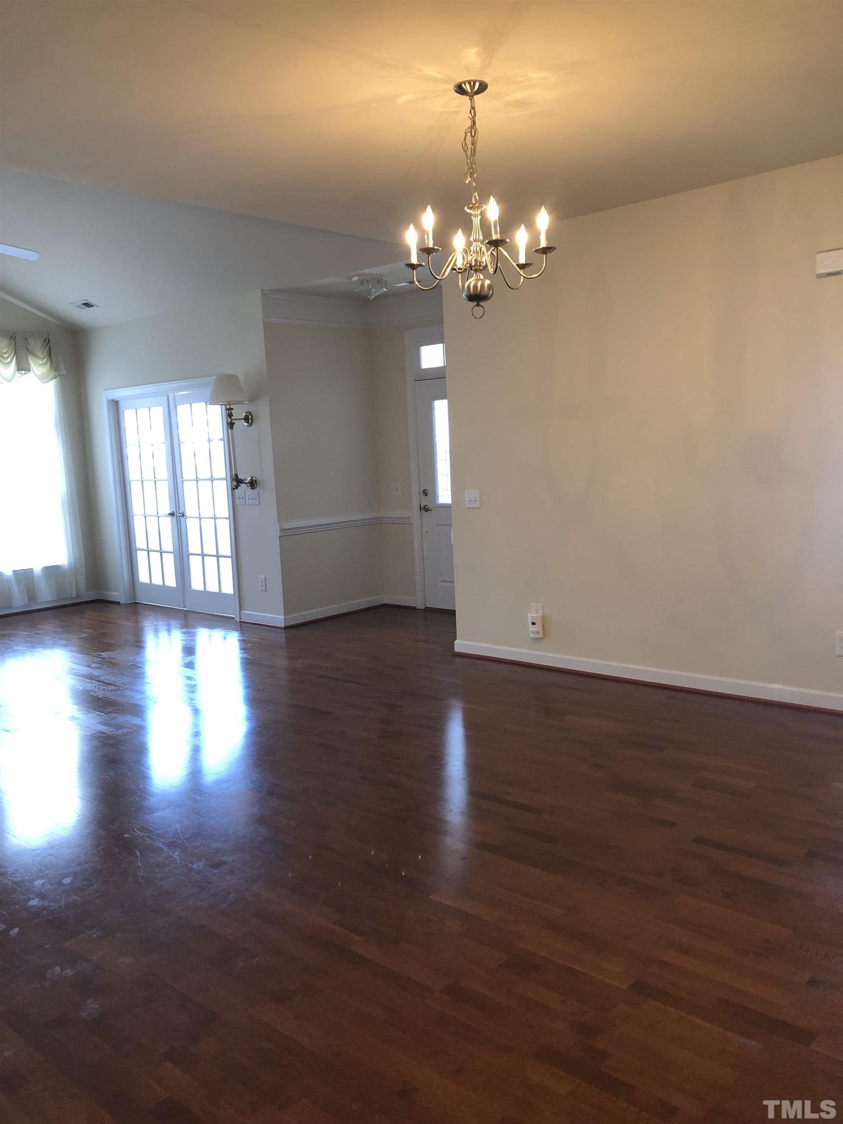 4720 Fox Fern Lane Raleigh, NC 27604 - Photo 9 of 20 a view of a room with wooden floor and chandelier