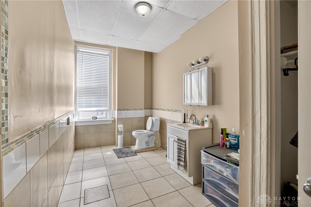 7045-7049 Montgomery Road Cincinnati, OH 45236 - Photo 48 of 68 This functional bathroom features a tiled floor and practical window for natural light.
