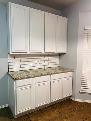 a view of a room with wooden floor and cabinet