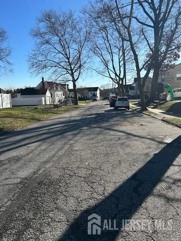 a view of street with large trees