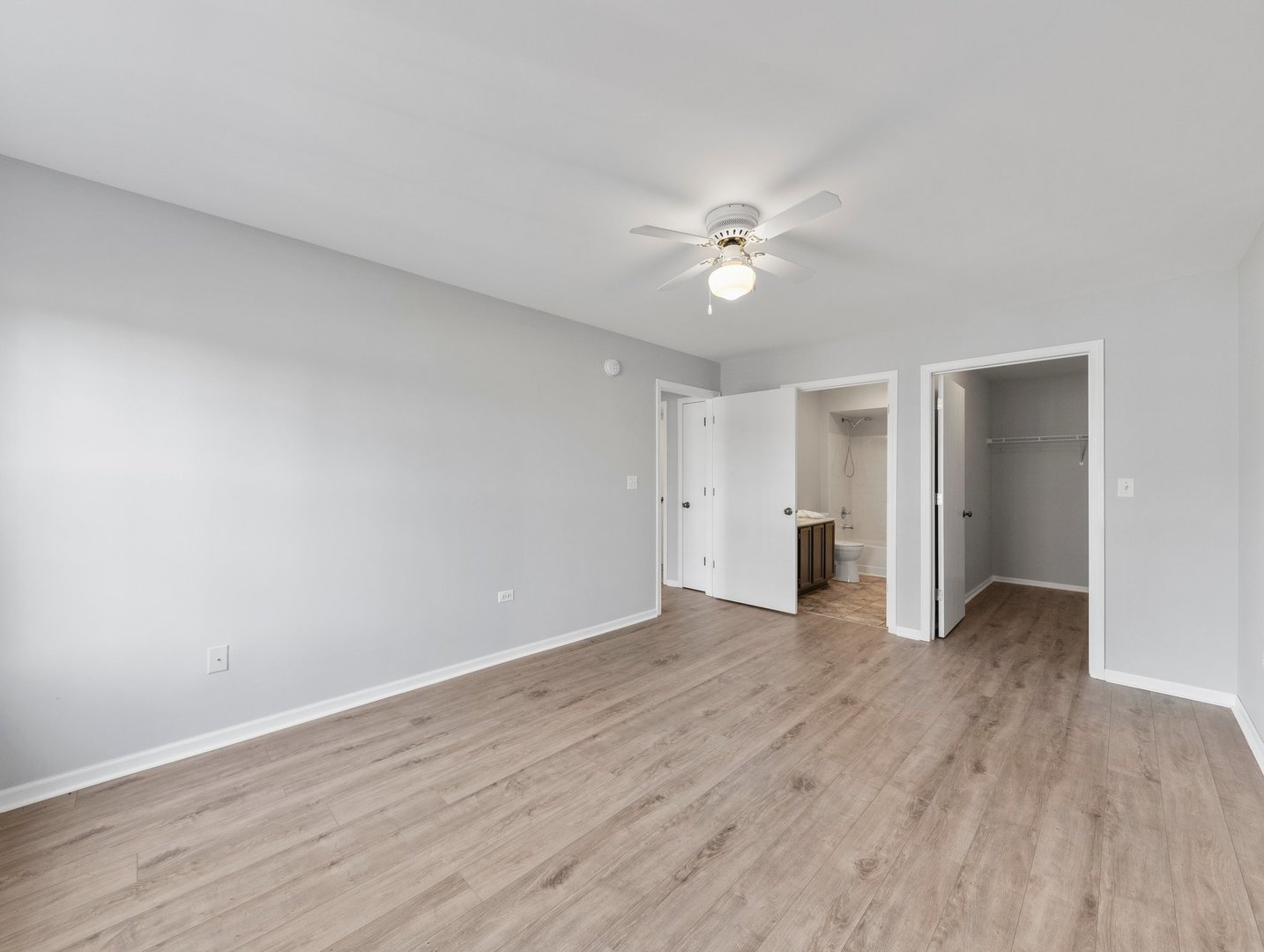 2503 Sheehan Drive, Unit 101 Naperville, IL 60564 - Photo 11 of 19 an empty room with wooden floor and ceiling fan