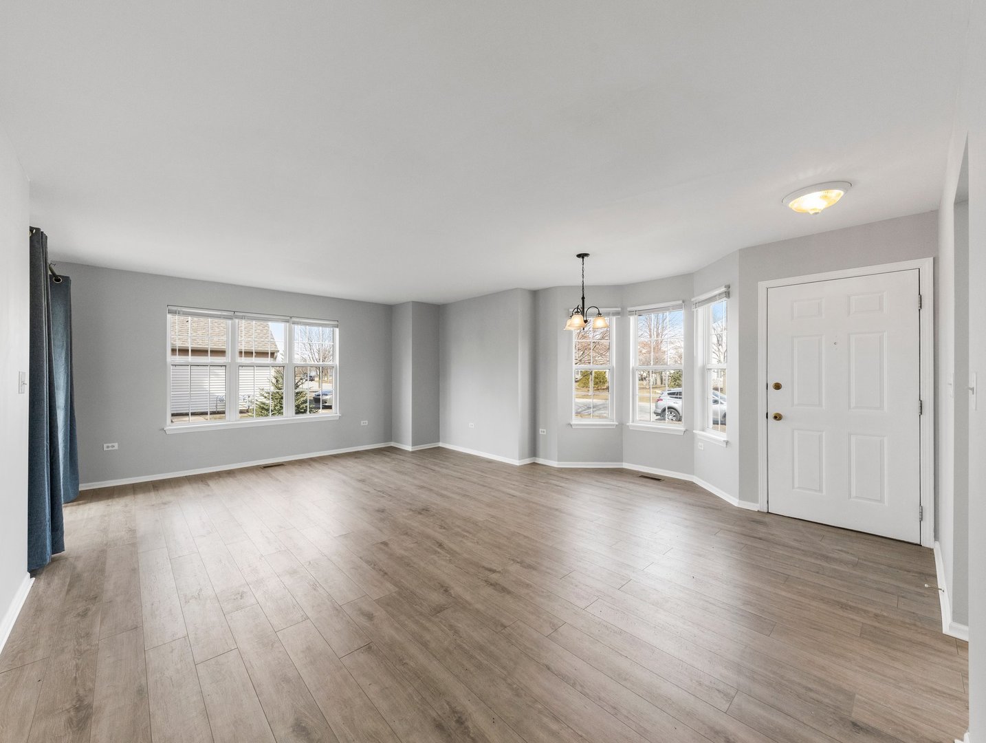 2503 Sheehan Drive, Unit 101 Naperville, IL 60564 - Photo 3 of 19 an empty room with wooden floor and windows