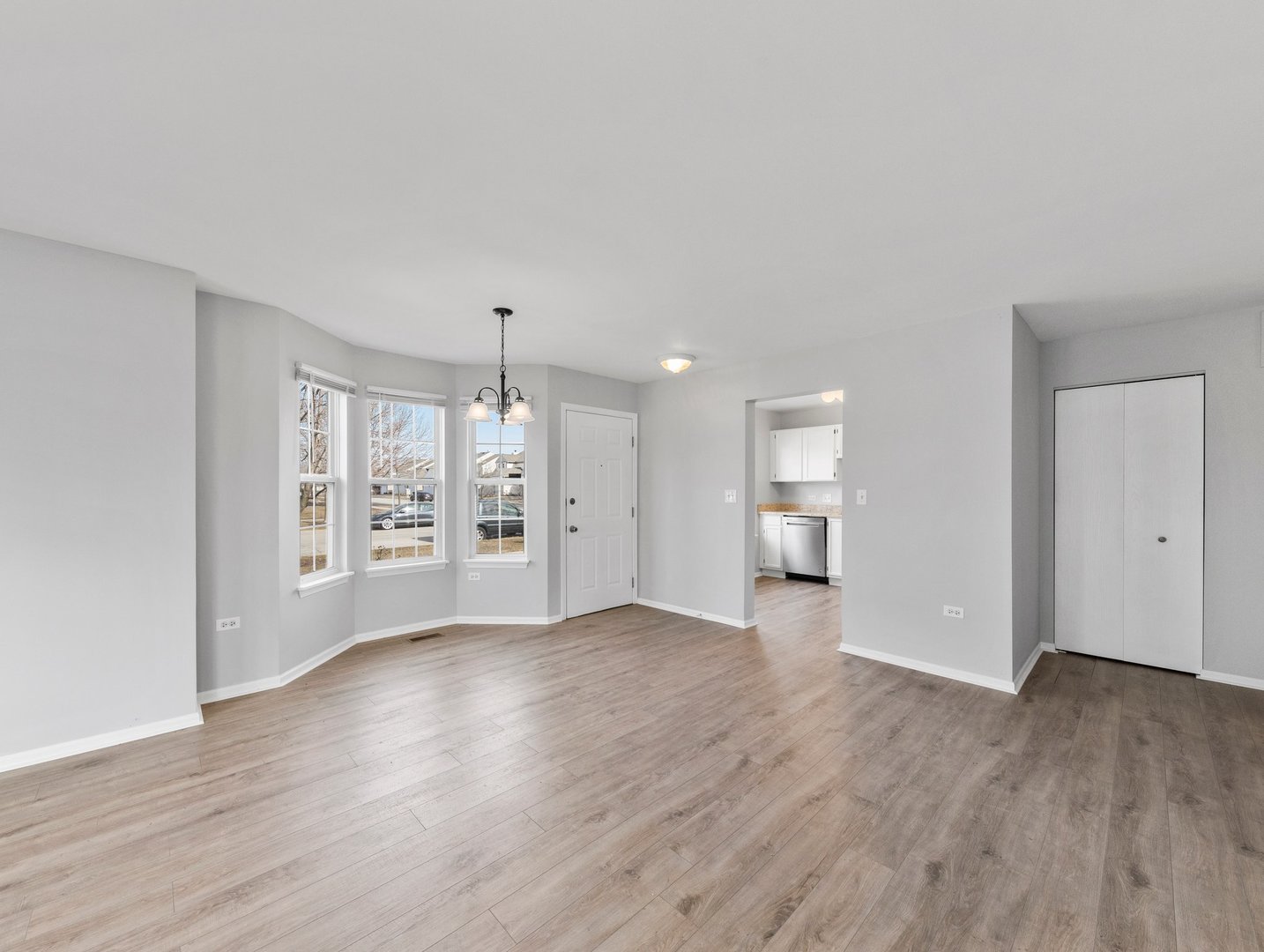 2503 Sheehan Drive, Unit 101 Naperville, IL 60564 - Photo 4 of 19 a view of an empty room with wooden floor and a window