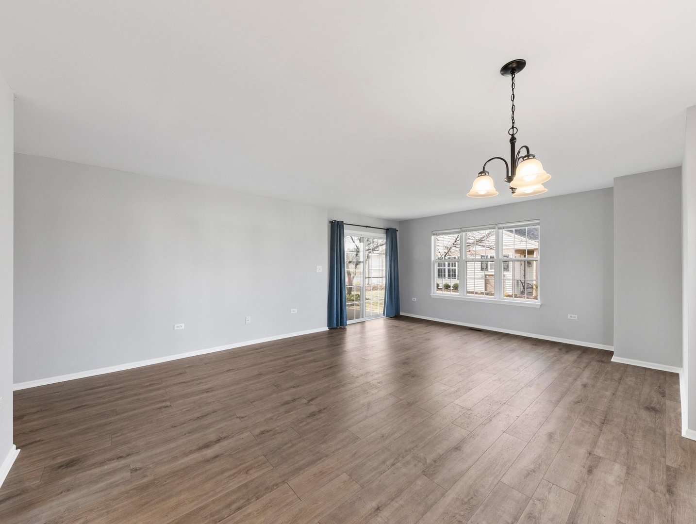 2503 Sheehan Drive, Unit 101 Naperville, IL 60564 - Photo 5 of 19 a view of an empty room with wooden floor and a window