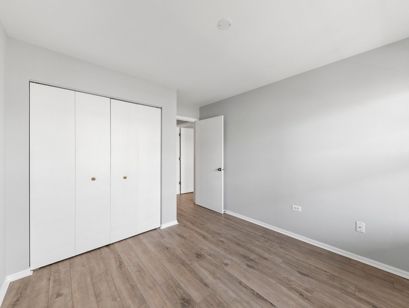 2503 Sheehan Drive, Unit 101 Naperville, IL 60564 - Photo 10 of 19 a view of an empty room with wooden floor