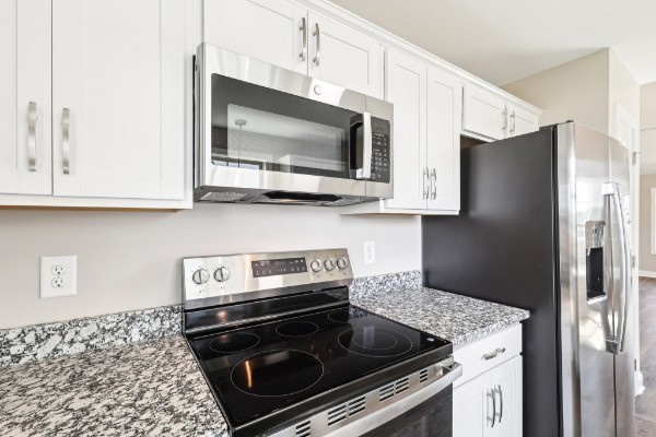 32 Echo Ridge Oak Grove, KY 42262 - Photo 9 of 42 a kitchen with stainless steel appliances granite countertop a stove microwave and refrigerator