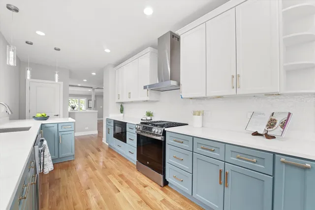 a kitchen with stainless steel appliances granite countertop a sink and cabinets